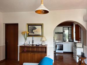 a living room with a blue couch and a kitchen at Villa Mesiano in Polistena