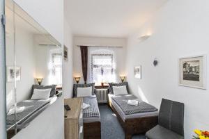 a living room with a couch and a table at Penzion Landauer in Český Krumlov
