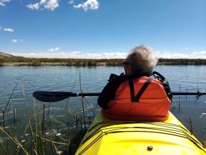 a man sitting in a kayak on a lake at Q'OTA TAYPY LODGE in Puno