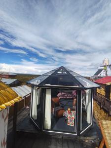 a small black house on top of a roof at Q'OTA TAYPY LODGE in Puno +6 photos