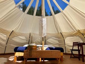 a large tent with a table in front of it at Hôtel UNIQ - Domaine Saint-Bernard - Tentes Glamping in Mont-Tremblant