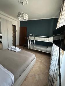 a bedroom with two bunk beds and a couch at Casa Palma in Rho