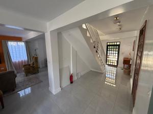 a living room with a staircase in a house at Prime Elgon View 5BR Family Home Private Secure in Eldoret +52 photos