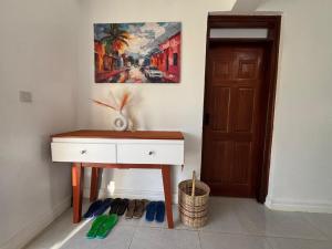 a room with a desk and a painting on the wall at Prime Elgon View 5BR Family Home Private Secure in Eldoret