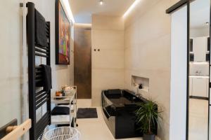 a living room with a sink and a bathroom at ART&SPA Koblenz in Koblenz