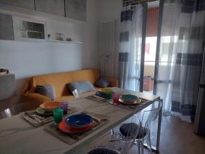 a living room with a table with plates of food on it at DaSimo in Lido di Fermo +5 photos