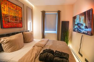 a bedroom with a large bed with a painting on the wall at ART&SPA Koblenz in Koblenz