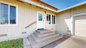 a home with stairs leading to a door and windows at Dog Friendly Oceanfront Home with Hot Tub & Views in Fort Bragg