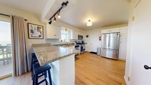 a kitchen with white cabinets and a counter top at Dog Friendly Oceanfront Home with Hot Tub & Views in Fort Bragg +36 photos