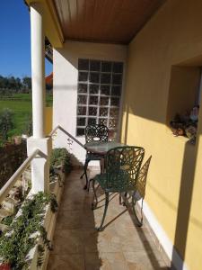 a patio with a table and chairs on a house at Casa Isabel in Póvoa dos Mosqueiros