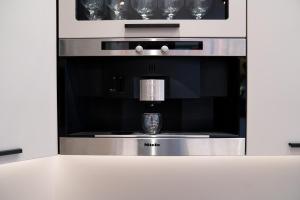 a kitchen with an oven with a coffee maker at ART&SPA Koblenz in Koblenz