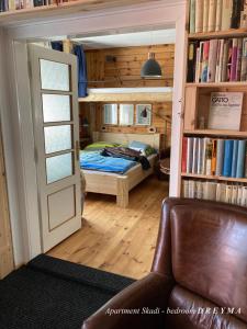 a bedroom with a bed in a room with a door at Cottage Scandi Dedinky in Dedinky