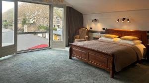 a bedroom with a bed and a large window at B&B Hotel Elselina in Schiedam