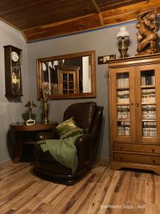 a leather chair in a room with a table and a mirror at Cottage Scandi Dedinky in Dedinky +35 photos