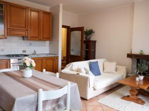 a kitchen and a living room with a couch and a table at Il nido di Lera in Lenno