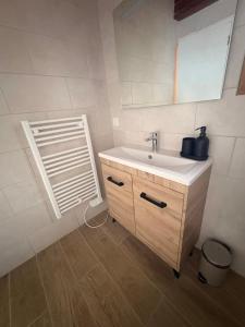 a bathroom with a sink and a mirror at Maison Bayle in Vignec