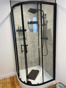 a shower with a glass door in a room at 3 Harbour Lights, Newlyn in Penzance +15 photos