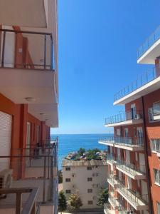 a view of the ocean from the balcony of a building at BlueWaveapartments 4 in Shëngjin +2 photos