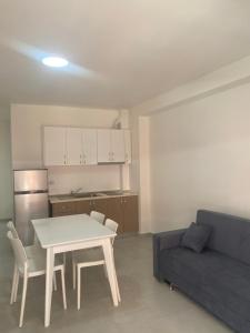 a living room with a table and a couch at BlueWaveapartments 4 in Shëngjin