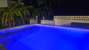 a swimming pool at night with blue lights at Bibi Beach Sunrise in La Trinité