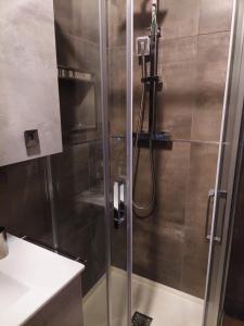 a shower with a glass door in a bathroom at DaSimo in Lido di Fermo