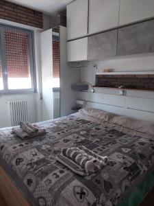 a bedroom with a bed with a rug on it at DaSimo in Lido di Fermo