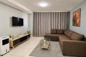 a living room with a couch and a table at Jubilee Stay in Windhoek