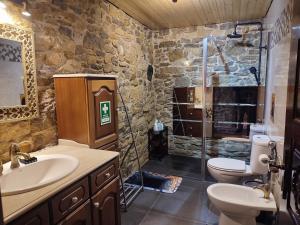 a stone bathroom with a sink and a shower at Sintra Knights Lodge in Terrugem +52 photos