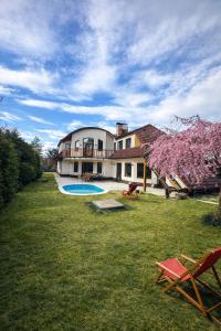 a large house with a swimming pool in a yard at Villa Grande Praha in Prague