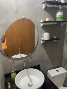 a bathroom with a sink and a mirror at Casa Lima Premium in Arapiraca