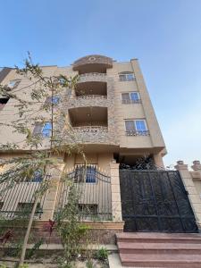 a building with a gate in front of it at Yousrys Nest Cozy Rooftop Studio in New cairo