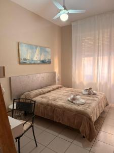 a bedroom with a bed with two stuffed animals on it at Hotel Gentile in Noli