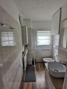a bathroom with a sink and a toilet and a shower at Appartamento Aurora - Passo del Tonale in Passo del Tonale +21 photos