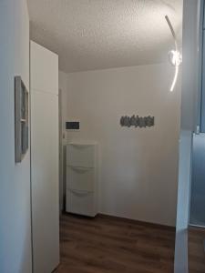 an empty room with a white wall and a ceiling at Appartamento Aurora - Passo del Tonale in Passo del Tonale