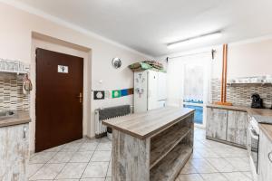 a kitchen with a wooden table in a room at Celá Horská Chata Maty - až 25 lůžek in Dolni Dvur +61 photos