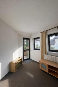 a living room with a table and two windows at Villa Grande Praha in Prague