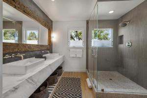 a bathroom with two sinks and a shower at Haven With Pool, Hot Tub And Tastings Included in Healdsburg