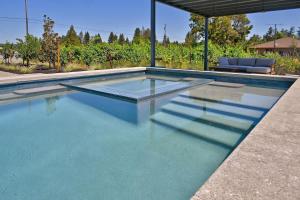 a swimming pool with blue water in a house at Haven With Pool, Hot Tub And Tastings Included in Healdsburg