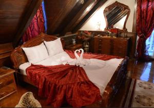 a bedroom with a large bed with a dresser at Guest House Vivaldi in Niš +41 photos