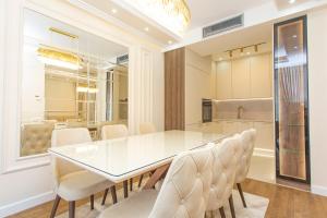 a dining room with a white table and chairs at Apartment Harmonia in Dobrota