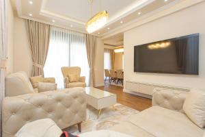 a living room with couches and a flat screen tv at Apartment Harmonia in Dobrota