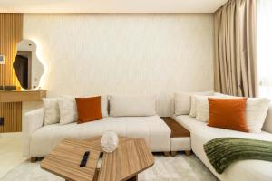a living room with a couch and a table at Appartement Uptown CFC - Piscine - Gym - Parking Gratuit in Casablanca