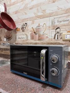 a microwave sitting on a counter in a kitchen at Al-Manara Hostel Siwa Oasis 2 in Siwa