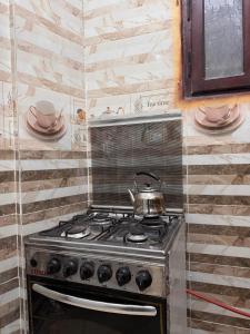 a stove with a tea pot on top of it at Al-Manara Hostel Siwa Oasis 2 in Siwa +32 photos