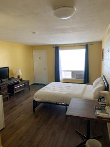 a bedroom with a large bed and a window at Spanish River Inn in Spanish