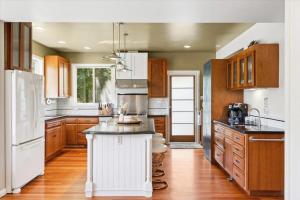 a kitchen with wooden cabinets and a white island at Bennett Valley Eden in Santa Rosa