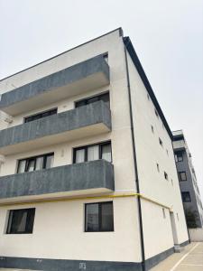 an apartment building with balconies on it at Cozy Nest in Constanţa