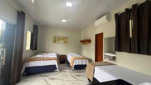a room with two beds and a mirror in it at Loft da 14 in Soure