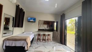 a bedroom with a bed and two stools at Loft da 14 in Soure