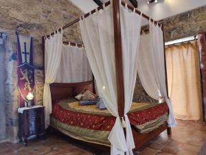 a bedroom with a canopy bed with curtains at Sintra Knights Lodge in Terrugem